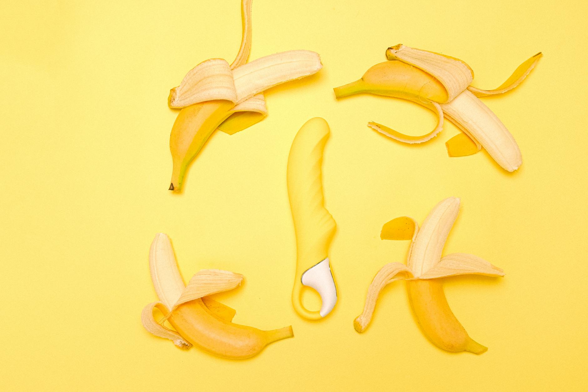 A yellow lemon vibrator surrounded by lemons on a bright yellow surface, representing renewal and sensual rediscovery.