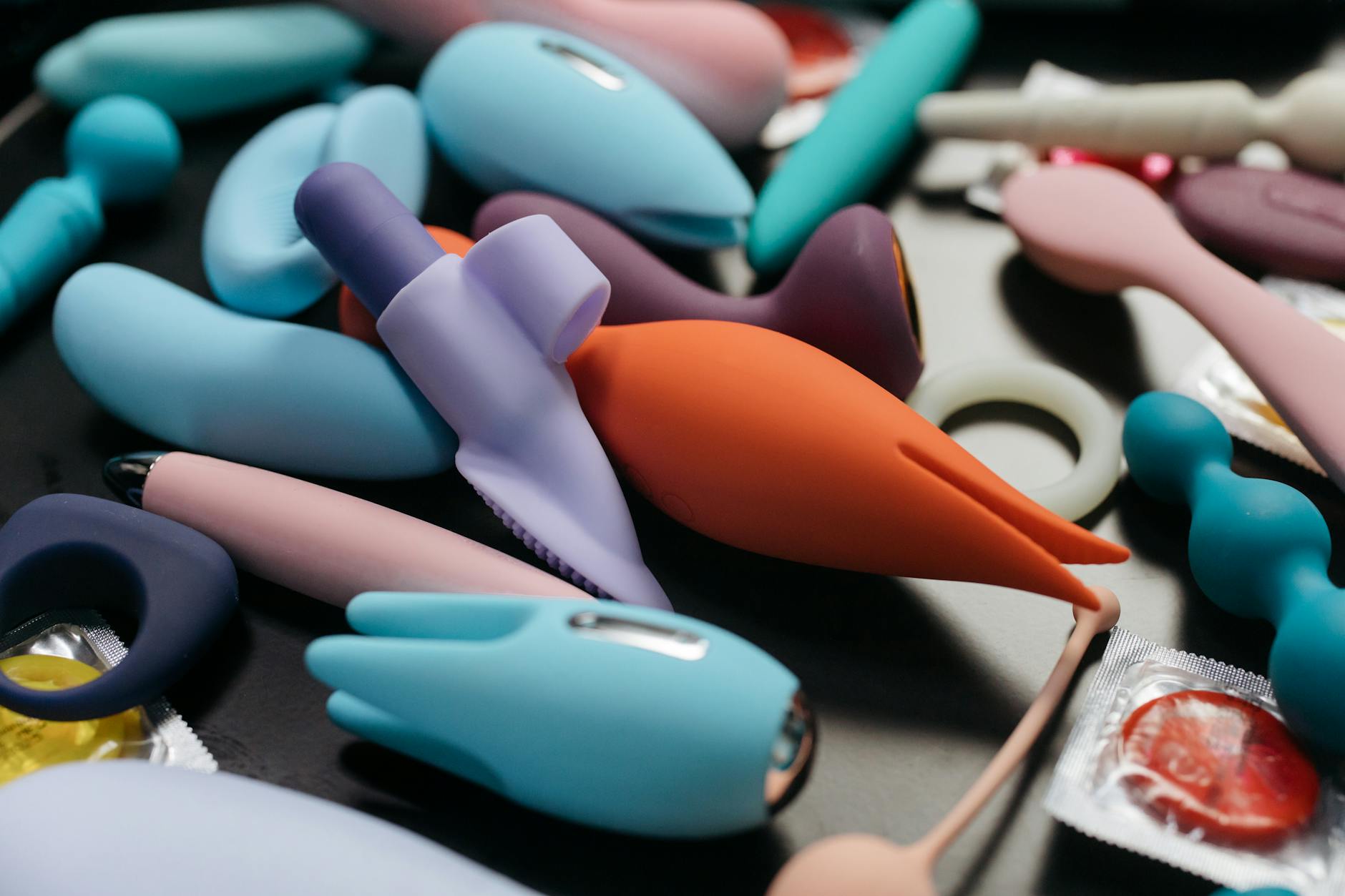 A woman holding a vibrator in soft light, symbolizing gentle reconnection with pleasure