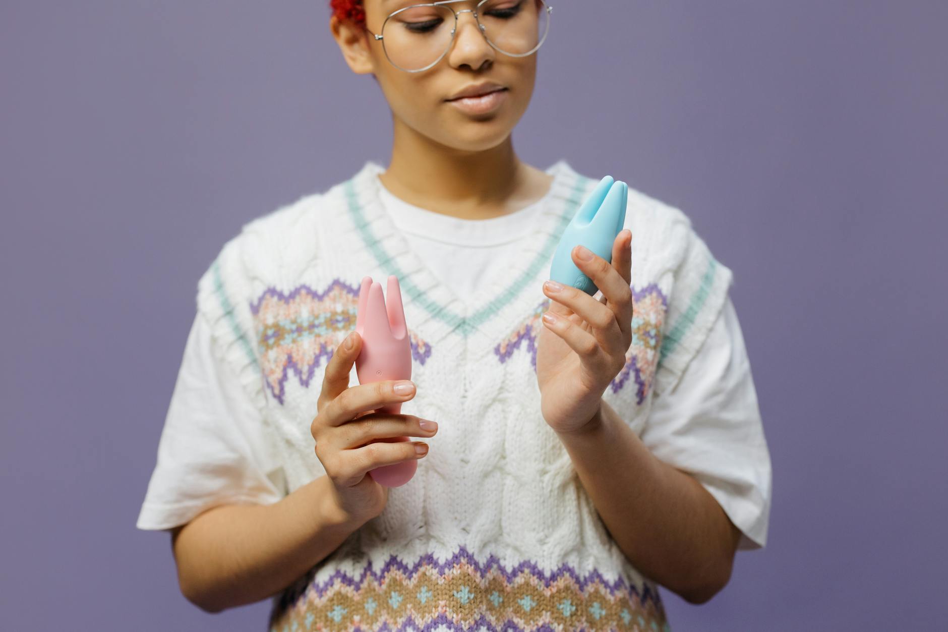 Woman comparing different clitoral vibrator styles and suction toys